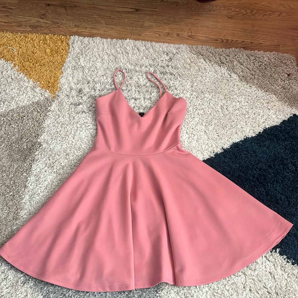 Pink dress, with pockets, fitted at the top flare bottom.